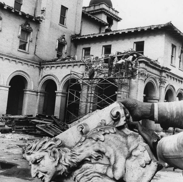 "End of the line. This 66-year-old gargoyle seems a bit broken up over demolition of Terminal Station, praised as a 'magnificent structure' upon its opening in 1905 and now crumbling under the onslaught of progress. The station is owned by the Southern Railway System. A spokesman for Southern in Washington said Tuesday the building is coming down 'because it's no longer used.' The Atlanta chapter of the National Railroad Historical Society Inc. retrieved numerous items of historical interest from the building after it was shut down in 1970, and now the demolition is entering its terminal stages. There are no immediate plans for use of the property, the Southern spokesman said. (Staff photo -- Guy Hayes)." Caption date-stamped: Jan 26 1972 Constitution.